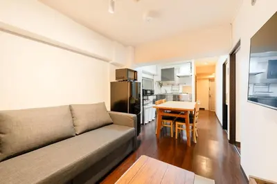 a living room with a couch and a table at \u30db\u30c6\u30eb\u5bcc\u58eb\u898b\u30de\u30f3\u30b7\u30e7\u30f3 in Tokyo