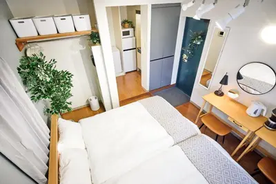 a small bedroom with a white bed and a desk at Quiet TOKYO Stay Kami-kitazawa in Wada
