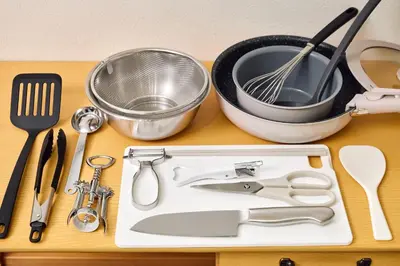a cutting board with kitchen utensils on a table at Quiet TOKYO Stay Kami-kitazawa in Wada