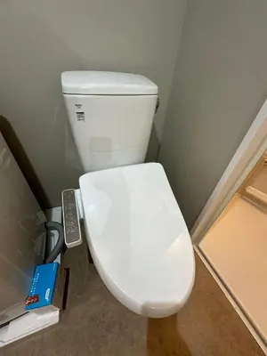 a white toilet in a bathroom with a remote control at \u65b0\u7bc9OPEN GREW OJI residence202 in Tokyo