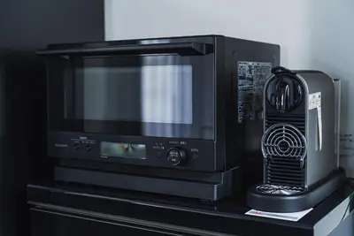 a microwave oven sitting on top of a table at SLL Urban Suites Ebisu in Tokyo