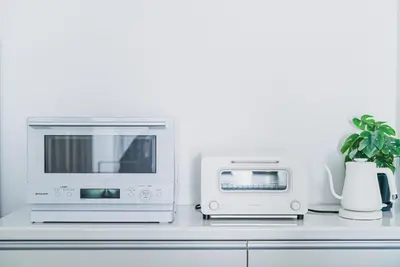 a microwave and a toaster oven on a kitchen counter at SLL Urban Suites Ebisu in Tokyo