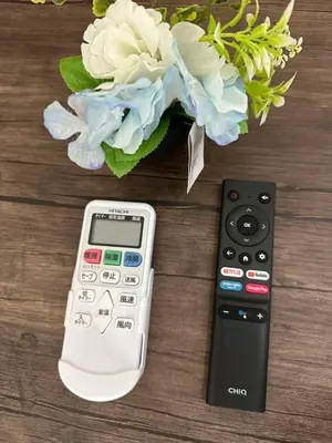 a calculator and a vase of flowers on a table at \u65b0\u7bc9OPEN GREW OJI residence301 in Tokyo