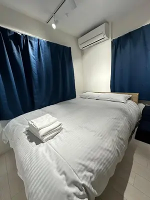 a bedroom with a bed with towels on it at \u65b0\u7bc9OPEN GREW OJI residence301 in Tokyo