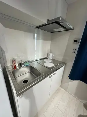 a small kitchen with a sink and a stove at \u65b0\u7bc9OPEN GREW OJI residence302 in Tokyo