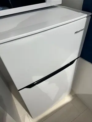 a white refrigerator freezer sitting in a kitchen at \u65b0\u7bc9OPEN GREW OJI residence401 in Tokyo