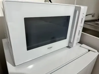 a microwave oven sitting on top of a shelf at \u65b0\u7bc9OPEN GREW OJI residence402 in Tokyo