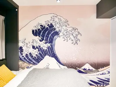 a mural of the wave on the wall of a bedroom at Triphome Asakusa Alpha 3min to Sensoji Temple in Tokyo