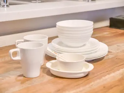 a group of white cups and plates on a table at Triphome Asakusa Alpha 3min to Sensoji Temple in Tokyo