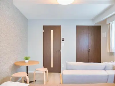 a living room with a couch and a table at Triphome Nakano 1 bedroom in Tokyo