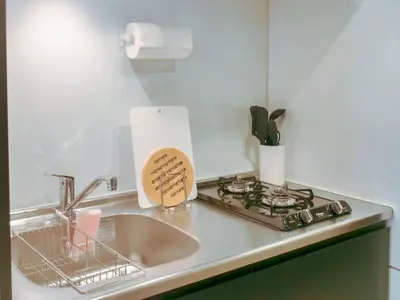 a kitchen counter with a sink and a stove at Triphome Nakano 1 bedroom in Tokyo