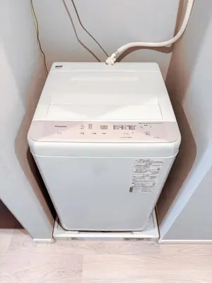 a white computer sitting on top of a wall at Triphome Nakano 1 bedroom in Tokyo
