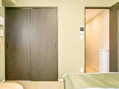 a sliding door in a room with a bed at Triphome Nakano Japanese Style in Tokyo