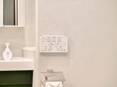 a white bathroom with a toilet and a sink at Triphome Nakano Japanese Style in Tokyo