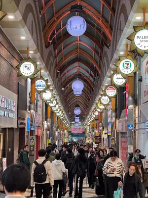 a crowd of people walking through a shopping mall at Triphome Nakano Japanese Style in Tokyo