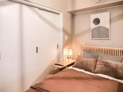 a bedroom with a large bed and a window at Triphome Asakusa 2 Bedrooms in Tokyo