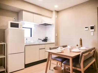 a kitchen and dining room with a table and chairs at Triphome Asakusa 2 Bedrooms in Tokyo