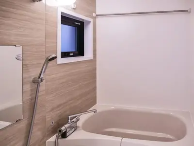 a bathroom with a bath tub with a tv on the wall at Triphome Asakusa 2 Bedrooms in Tokyo