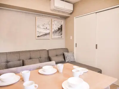 a living room with a table and a couch at Triphome Asakusa Alpha 2 Bedrooms in Tokyo