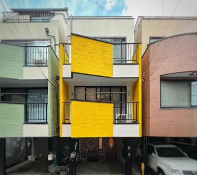 a building with yellow doors and balconies on it at OMOYI-HOUSE Spacious 3BR Sleeps 10 in Shinjuku-Yoyogi Private 4 Floors with Big Balcony Near Gyoen Takashimaya Isetan in Tokyo