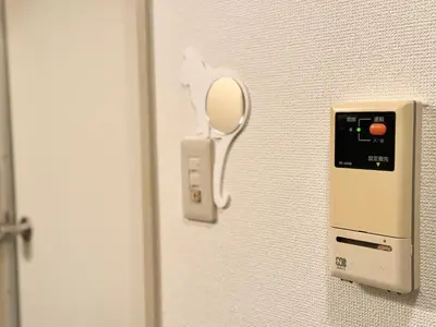 a mirror on a wall next to a door at Ikebukuro Sugamo B01 in Tokyo