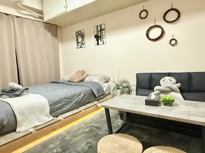 a bedroom with a bed and a table at Ikebukuro Sugamo B01 in Tokyo