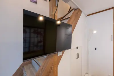 a flat screen tv on a wall in a room at Tokyo Akabane 2BR MAX5, Ikebukuro Shinjuku Ueno Ginza in Tokyo
