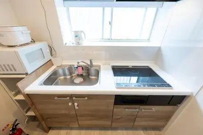 a small kitchen with a sink and a microwave at Tokyo Akabane 2BR MAX5, Ikebukuro Shinjuku Ueno Ginza in Tokyo