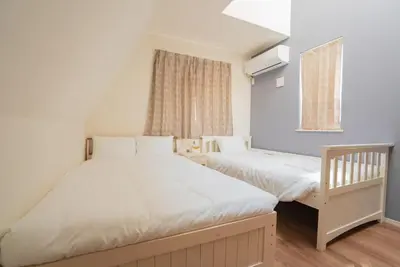 a bedroom with two beds and a window at \u6c60\u888b\u6238\u5efa in Tokyo
