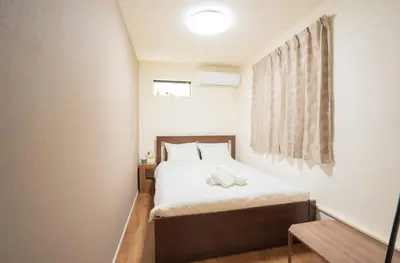 a small bedroom with a bed and a window at \u6c60\u888b\u6238\u5efa in Tokyo