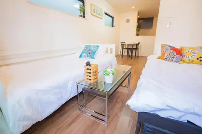 a living room with a white couch and a table at \u6c60\u888b\u6238\u5efa in Tokyo