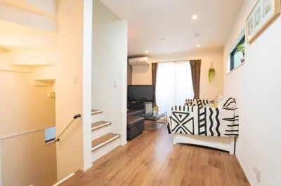 a living room with a couch and a chair at \u6c60\u888b\u6238\u5efa in Tokyo