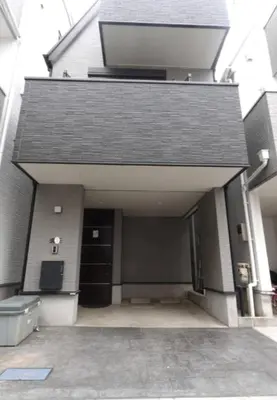 a building with a large garage with a door at \u6c60\u888b\u6238\u5efa in Tokyo