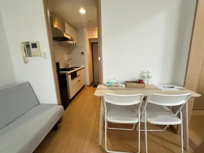 a small kitchen with a table and chairs in a room at Sunshine Grand Hotel Ikebukuro in Tokyo
