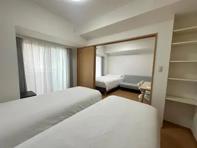a hotel room with two beds and a window at Sunshine Grand Hotel Ikebukuro in Tokyo