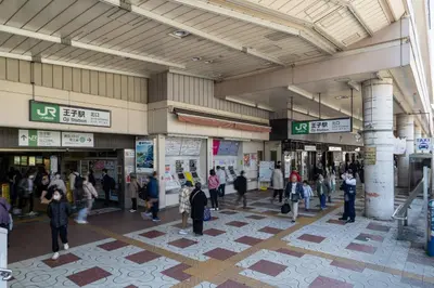 a group of people walking inside of a building at GLiCION\u738b\u5b50 in Tokyo