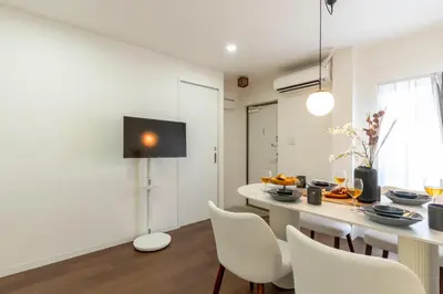 a kitchen and dining room with a table and chairs at T4U Shinjyuku Okubo in Tokyo