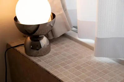 a lamp sitting on a table in a bathroom at T4U Shinjyuku Okubo in Tokyo