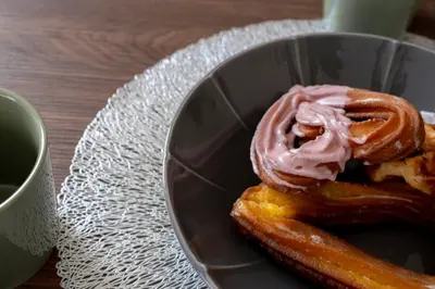 a bowl with a doughnut with pink icing on it at T4U Shinjyuku Okubo in Tokyo