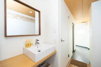 a bathroom with a white sink and a mirror at Ueno-an 4,5F in Tokyo