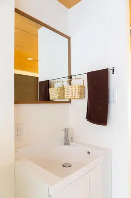 a bathroom with a white sink and a mirror at Ueno-an 4,5F in Tokyo