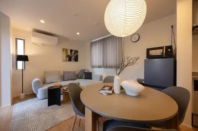 a living room with a table and a couch at Kutsurogi Sumida House \u304f\u3064\u308d\u304e\u30b9\u30df\u30c0\u30cf\u30a6\u30b9 in Tokyo
