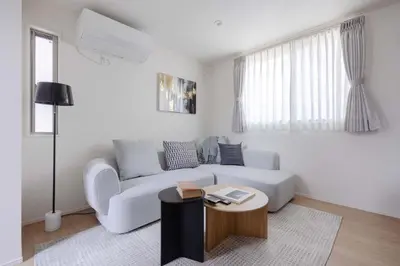 a living room with a white couch and a table at Kutsurogi Sumida House \u304f\u3064\u308d\u304e\u30b9\u30df\u30c0\u30cf\u30a6\u30b9 in Tokyo