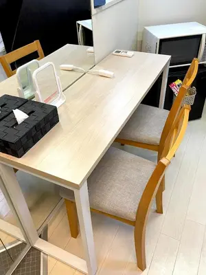 a wooden table with two chairs and a laptop at Budget Private StayIkebukuro Anime Area Sleeps 7 in Tokyo