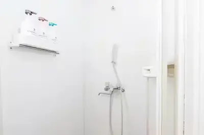 a bathroom with a shower and a door at Budget Private StayIkebukuro Anime Area Sleeps 7 in Tokyo