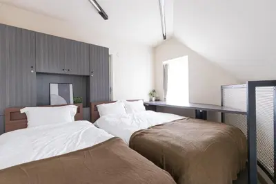two beds sitting next to each other in a bedroom at Budget Private StayIkebukuro Anime Area Sleeps 7 in Tokyo