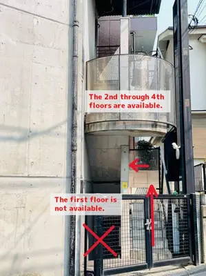 a sign is posted on the side of a building at Budget Private StayIkebukuro Anime Area Sleeps 7 in Tokyo