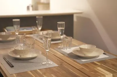 a table with plates and glasses on a wooden table at Friendly In Shinjuku \u30d5\u30ec\u30f3\u30c9\u30ea\u30fc\u30a4\u30f3\u65b0\u5bbf in Tokyo