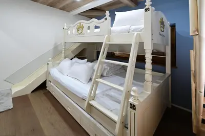 a bunk bed with white bunk beds in a room at Rakuna Inn \u5bdb sasazuka3 in Tokyo