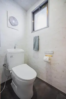 a bathroom with a white toilet and a window at \u30a2\u30d0\u30f4\u6e0b\u8c37\u30d3\u30eb2\u968e in Tokyo